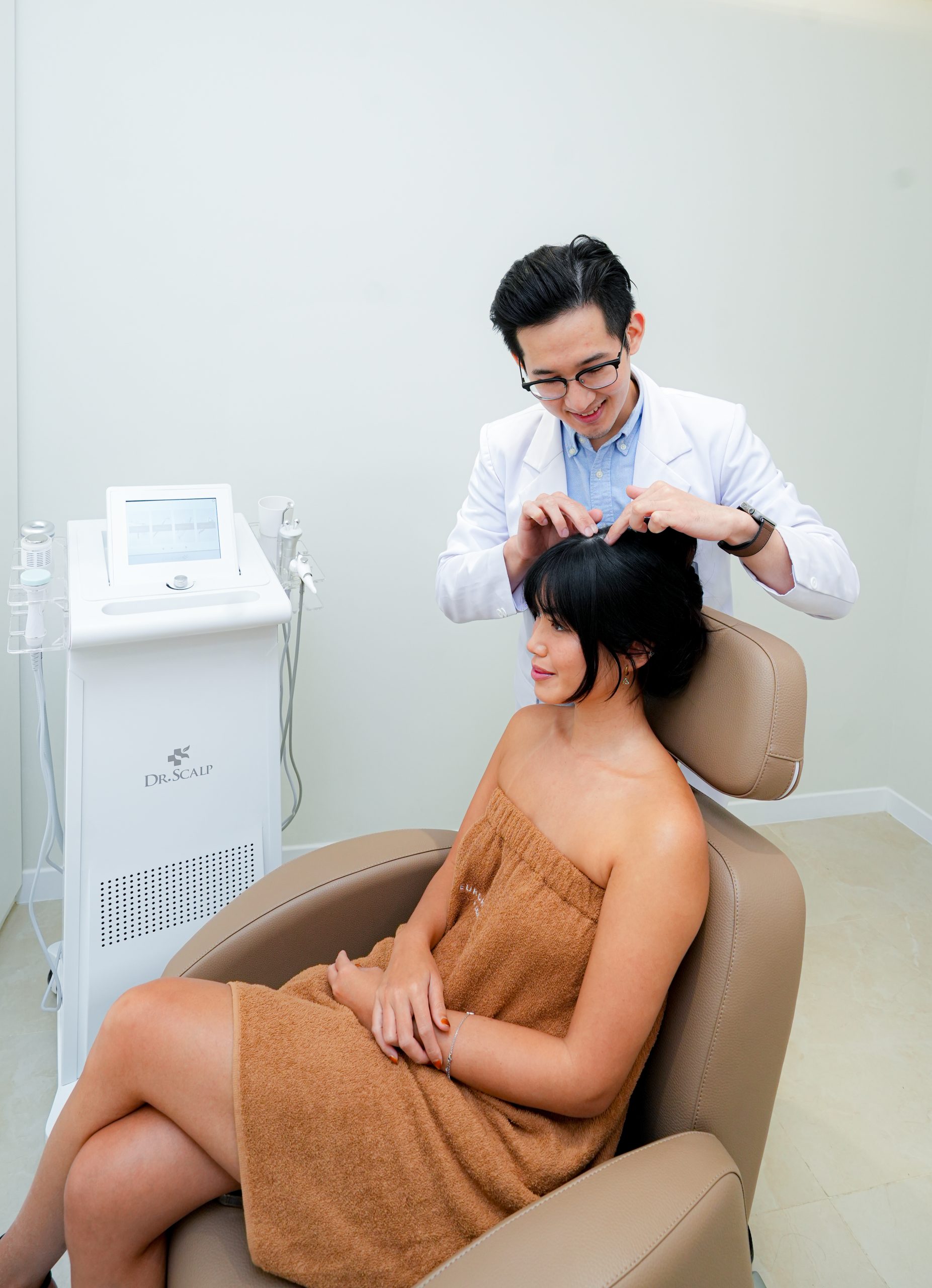 Woman holding scalp-care product